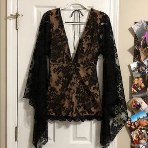 Black lace romper with low cut v neck and tie